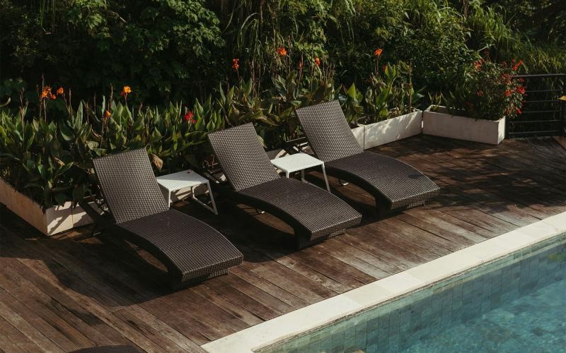 a group of chairs around a pool