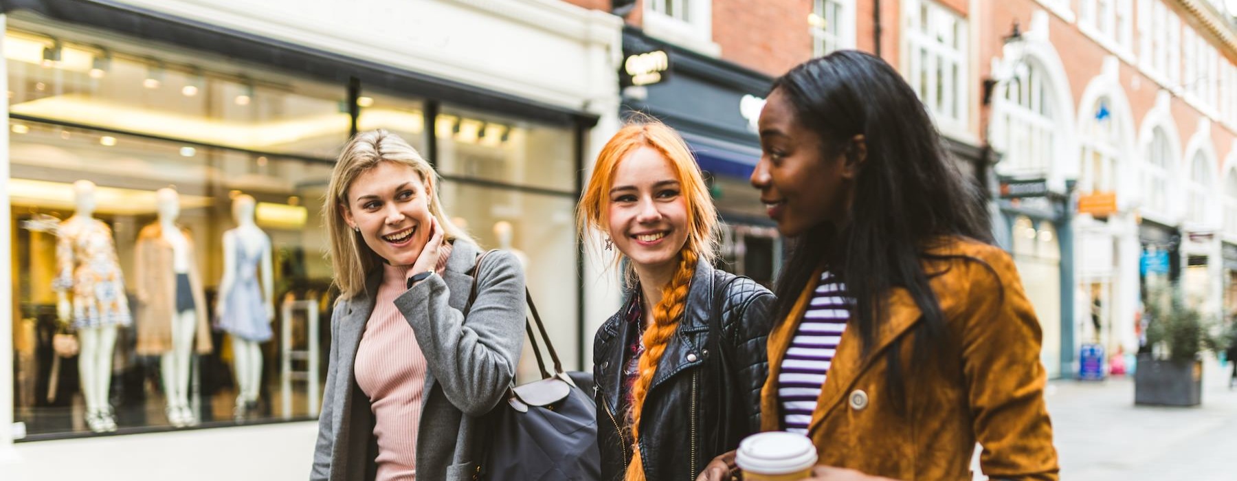 three women walking in a city